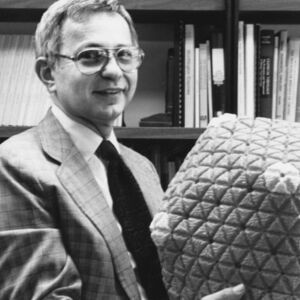 Bernard Roizman, ScD, holding a model of the herpes simplex virus capsid.
